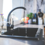 Improving a sink by installing a new faucet.